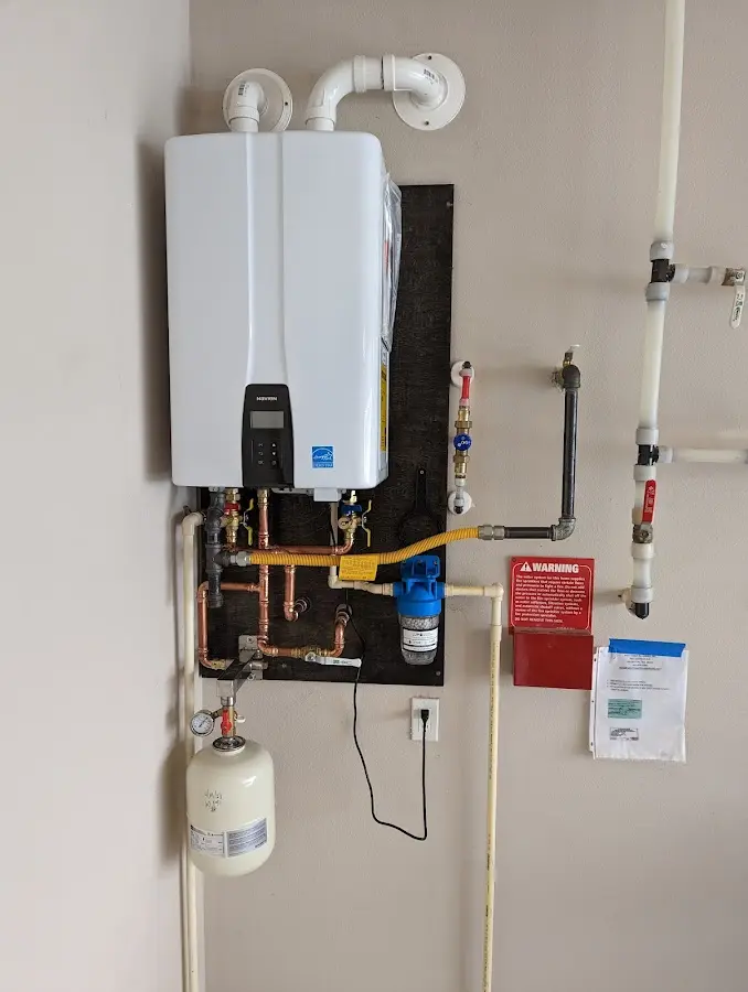 Professional plumber installing copper piping in a Schuyler Falls home